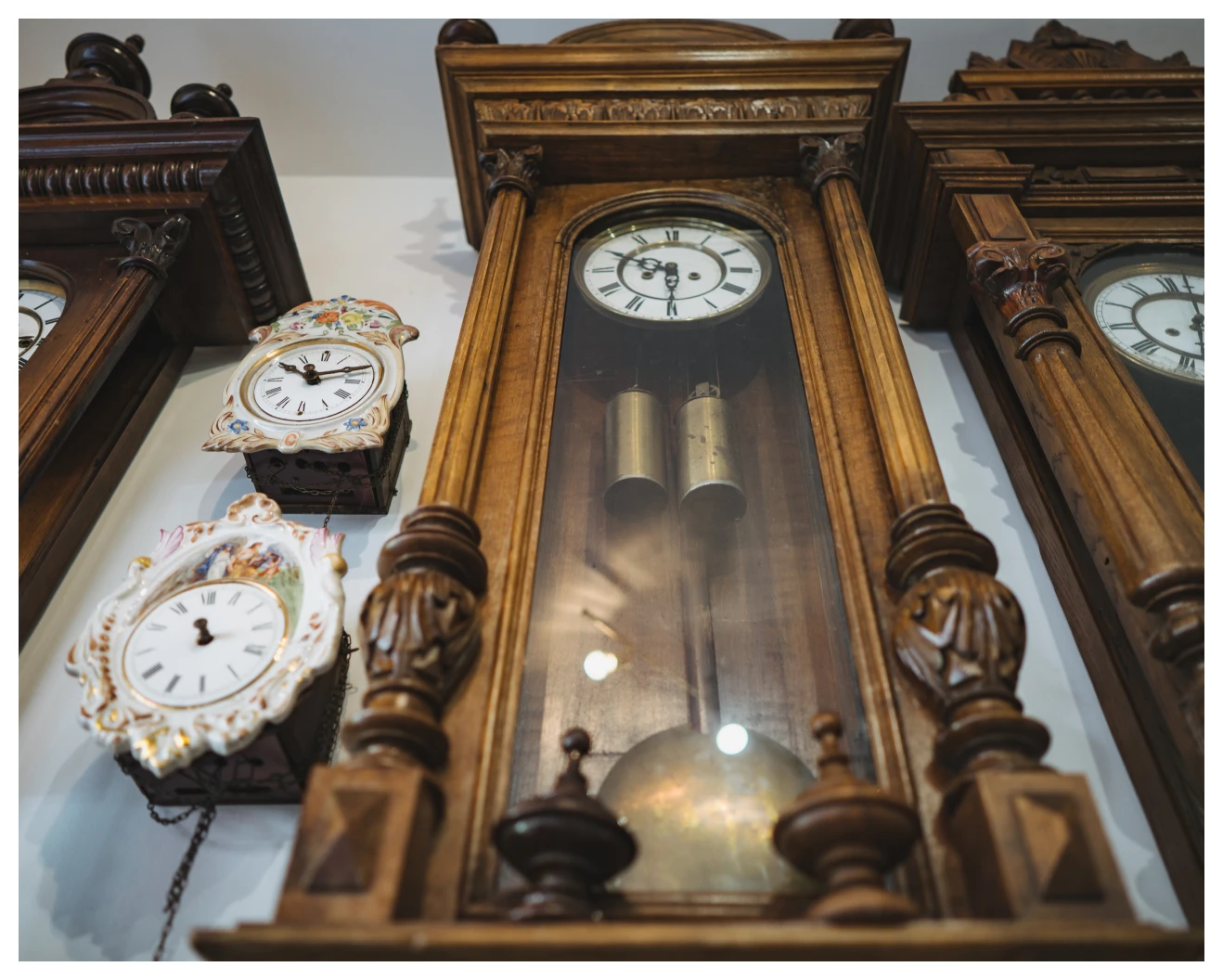 Ornate pendulum clocks on wall