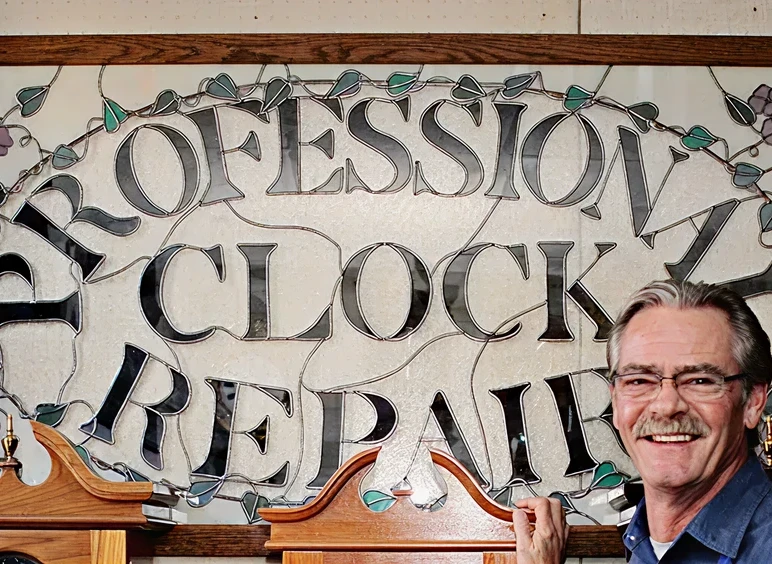 Smiling man in front of repair sign